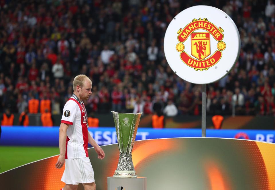  A dejected Davy Klaassen walks past the Europa League trophy