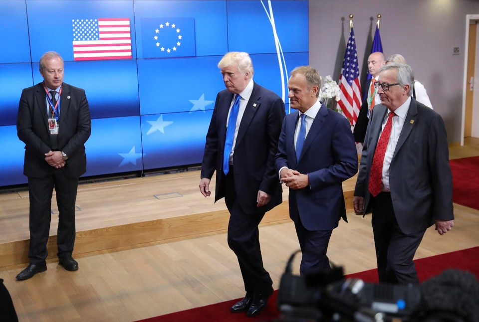 US President Donald Trump leaves the Europa building in Brussels with European Council President Donald Tusk, center, and European Commission President Jean-Claude Juncker, right