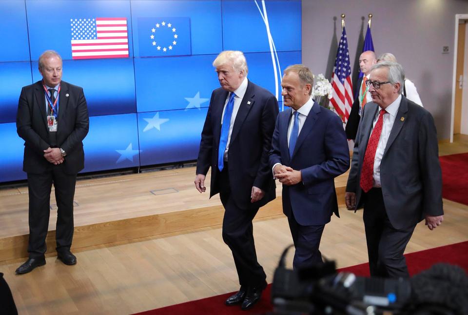  US President Donald Trump leaves the Europa building in Brussels with European Council President Donald Tusk, center, and European Commission President Jean-Claude Juncker, right