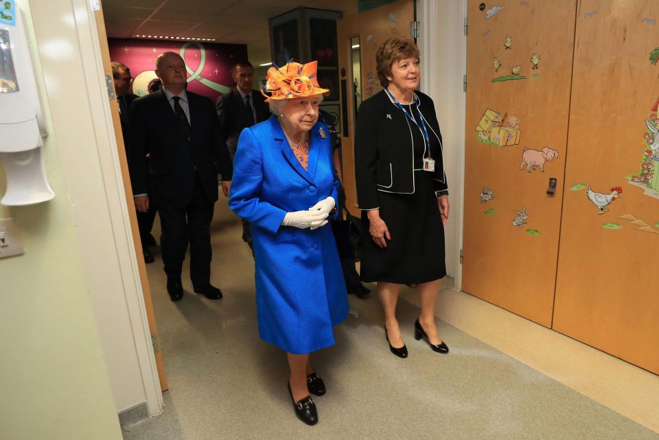  Her Maj walks through the hospital, where victims of the bomb are being treated