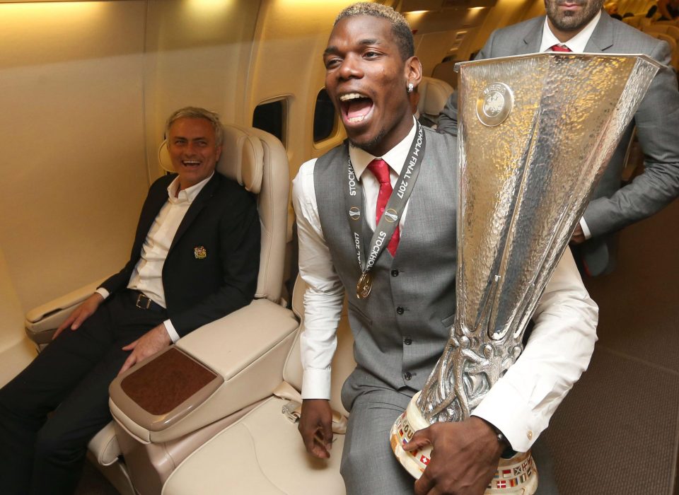  Paul Pogba yells for joy with manager Jose Mourinho and the Europa League trophy