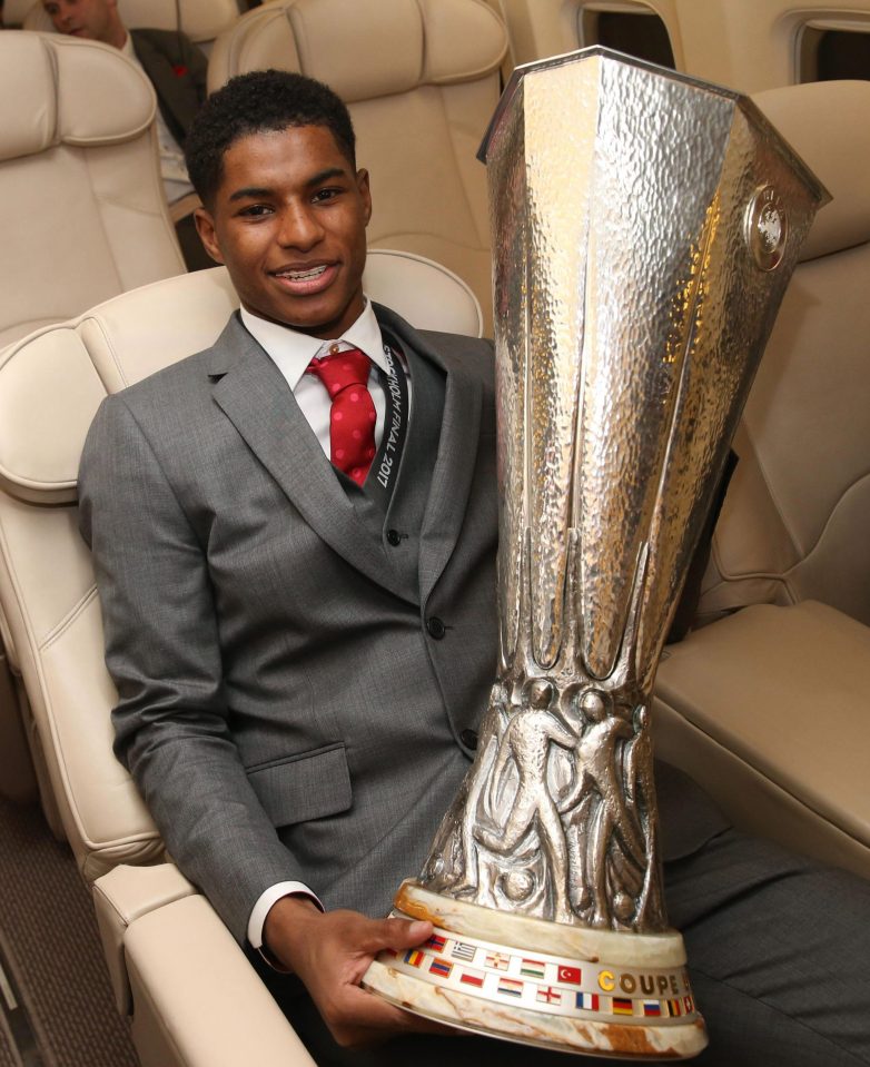  Marcus Rashford relaxes with the massive Europa League trophy