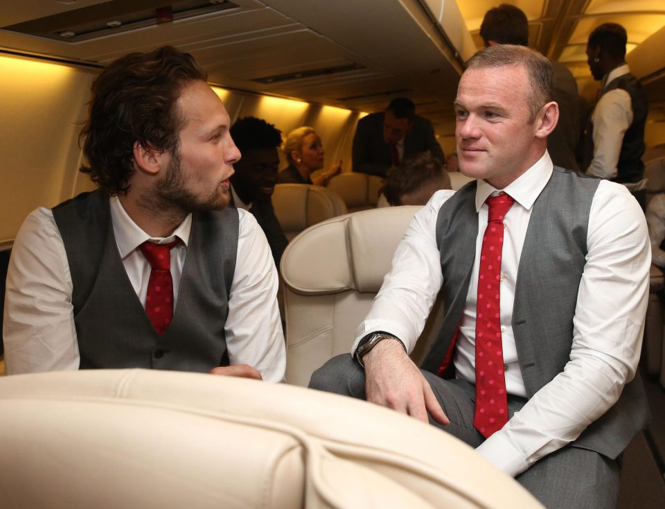  Daley Blind and Wayne Rooney chat on the flight to Manchester on Wednesday night