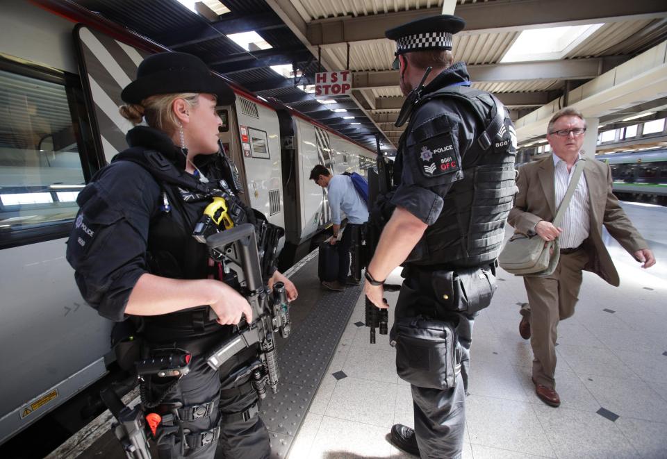  Armed police patrol the platform at Euston