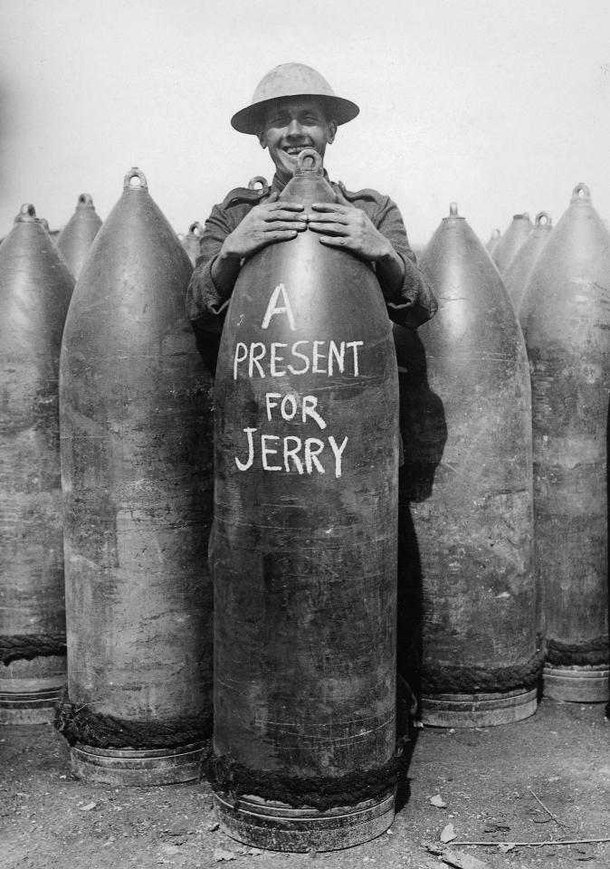  A First World War Tommy clutches a giant missile on which a message for the German enemy is written