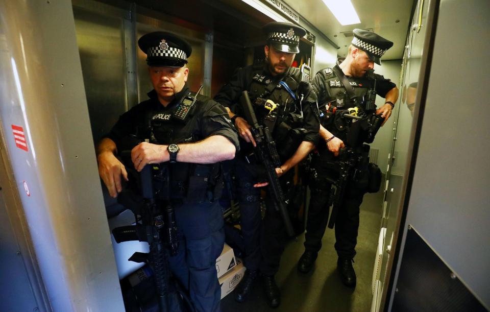  Armed police patrol a train in Milton Keynes today as security is stepped up