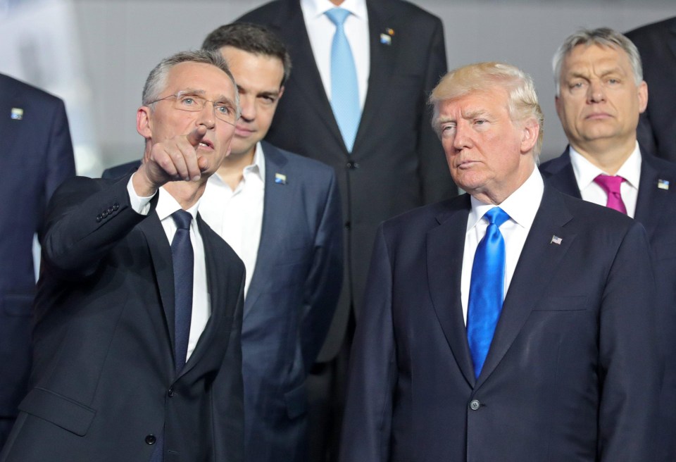 NATO Secretary General Jens Stoltenberg gestures next to US President Donald Trump