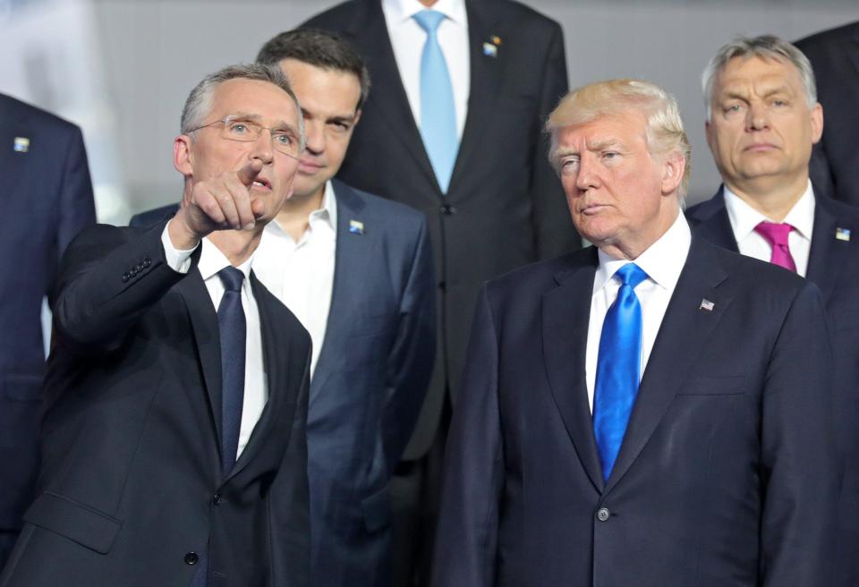  NATO Secretary General Jens Stoltenberg gestures next to US President Donald Trump