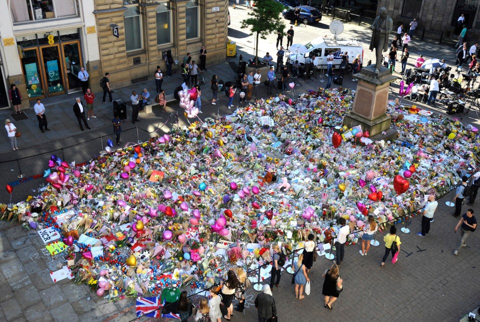 The incredible memorial has sprung up in the heart of Manchester just a few streets from the scene of Monday's attack