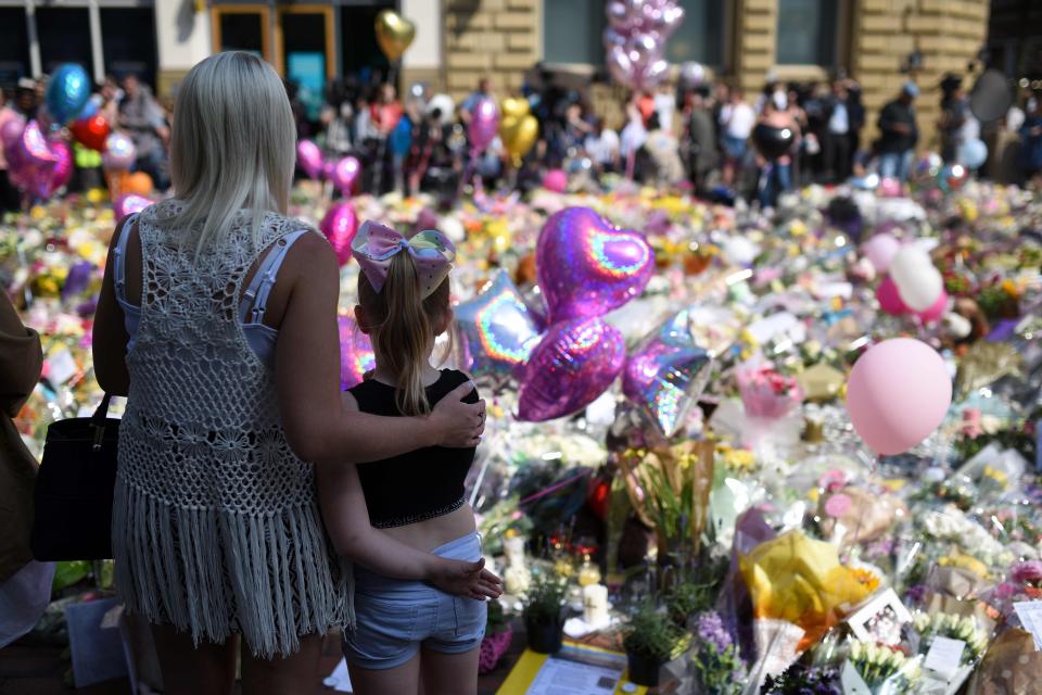  People gather to see flowers and messages of support in St Ann's Square in Manchester