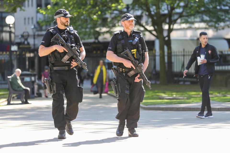  Armed police patrol a park in Birmingham. Poeple are being urged to register for EmergencySMS