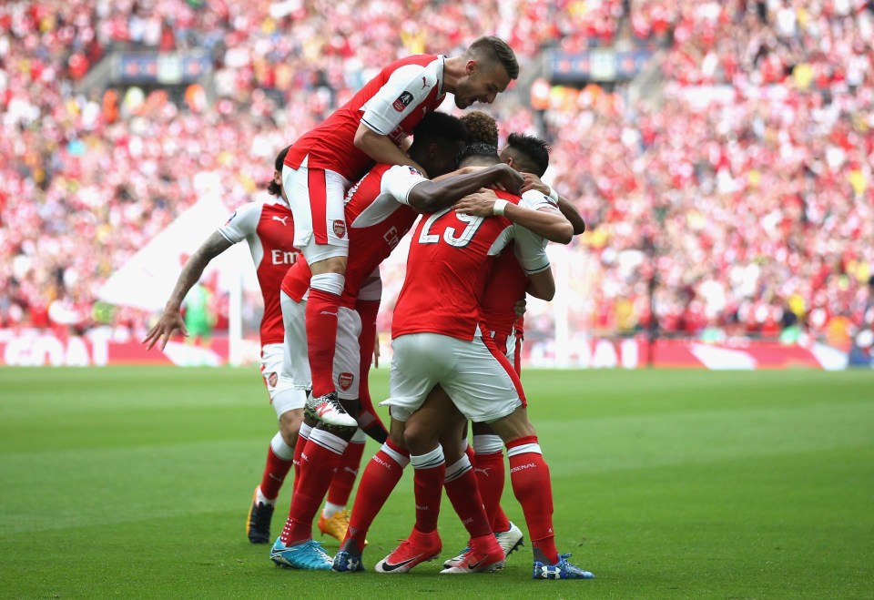 Alexis Sanchez is mobbed by his team-mates after opening the scoring