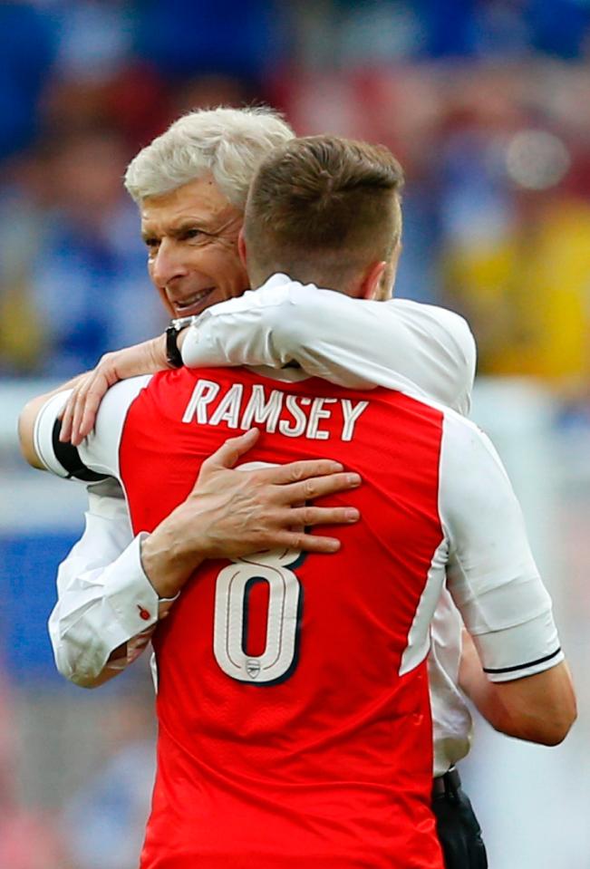  Arsene Wenger celebrates with the matchwinner Aaron Ramsey