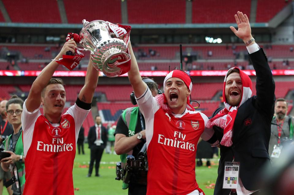  Mesut Ozil, Granit Xhaka and Shkodran Mustafi celebrate their FA Cup win