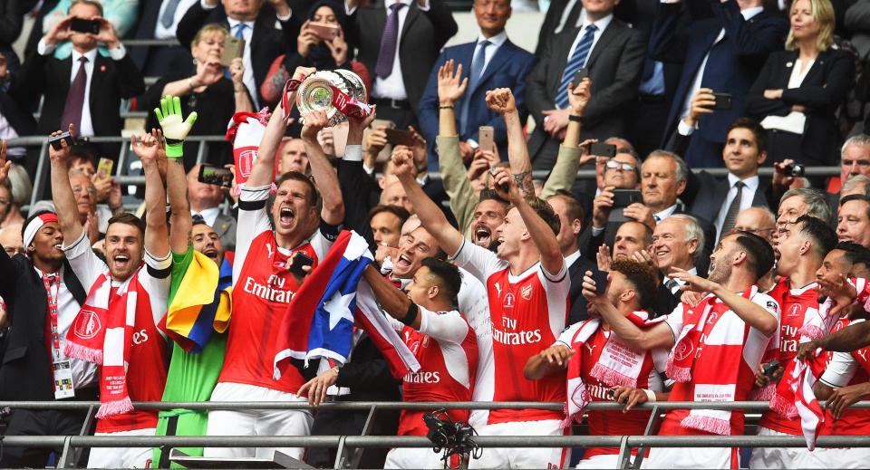  Per Mertesacker lifts the FA Cup as Arsenal beat Chelsea 2-1 with Wembley win