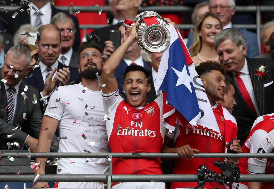  Alexis Sanchez lifts the FA cup as he celebrates with team mates