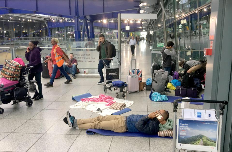  Plane passengers lie scattered on the floor at Heathrow Airport as the flight chaos entered its second day