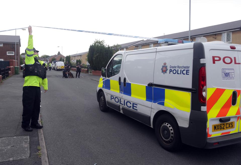  A police van marks the edge of the cordon