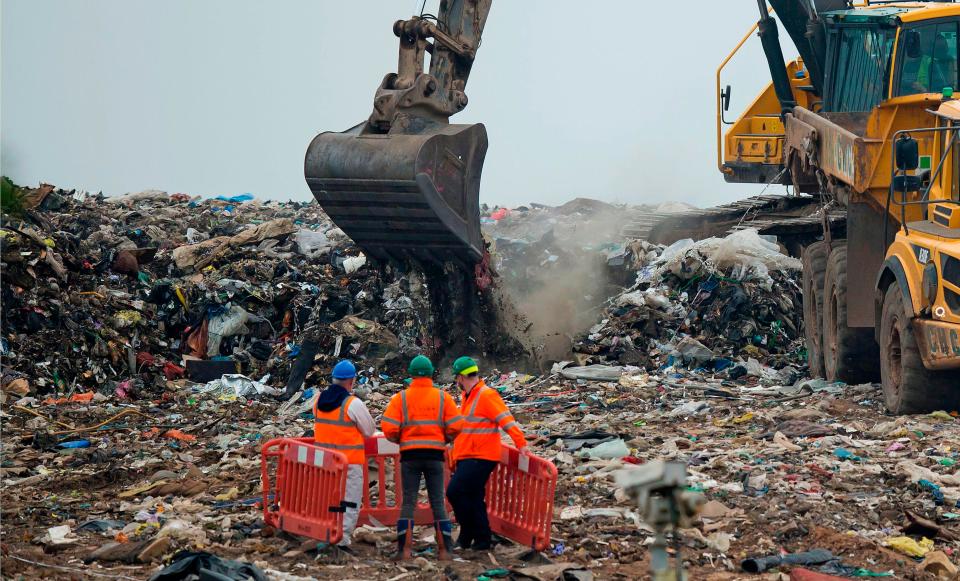  A digger picks up piles of waste at the Viridor Waste Management site in Greater Manchester