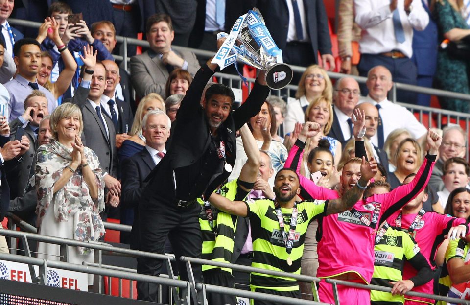  David Wagner celebrates with the trophy at Wembley after getting his side to the Prem