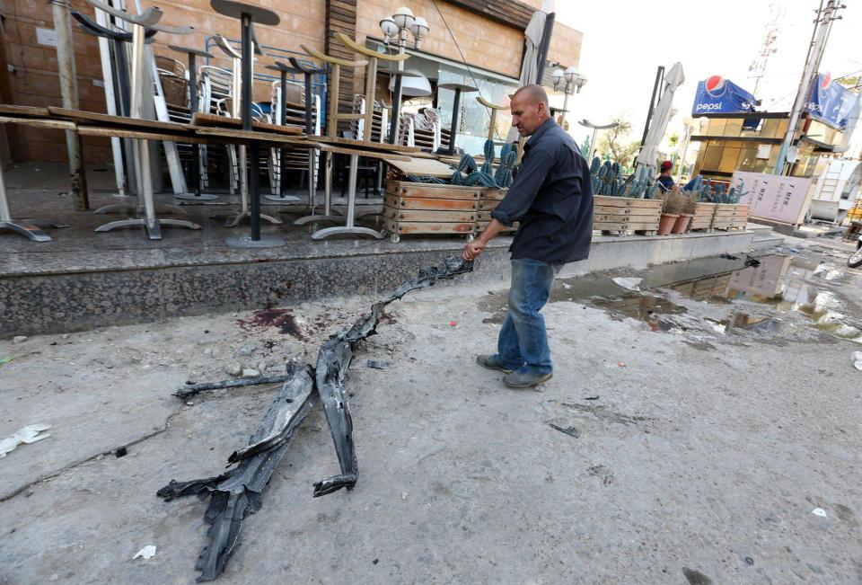  A local looks at wreckage left at the scene of last night's attack