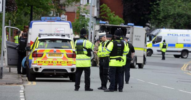 Terror police and bomb disposal units search a property in Wigan