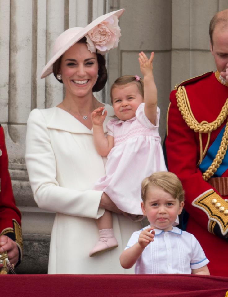  Kate Middleton beams beside Prince William, and Prince George while holding Princess Charlotte