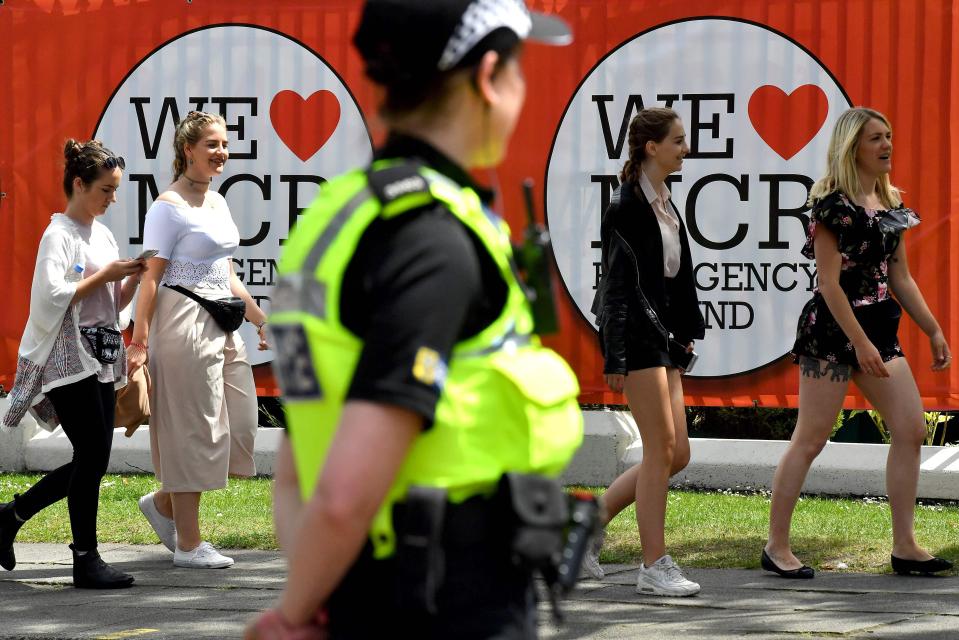  Armed police stand guard at Old Trafford in Manchester as youngsters arrived at the concert