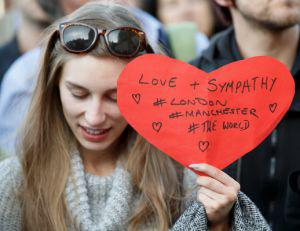 While another Labour supporter holds up a heart with ‘Love and sympathy #London #Manchester #Theworld’ written on it