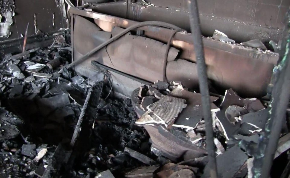 A charred bath that once belonged to a Grenfell Tower resident lies under a pile of warped metal