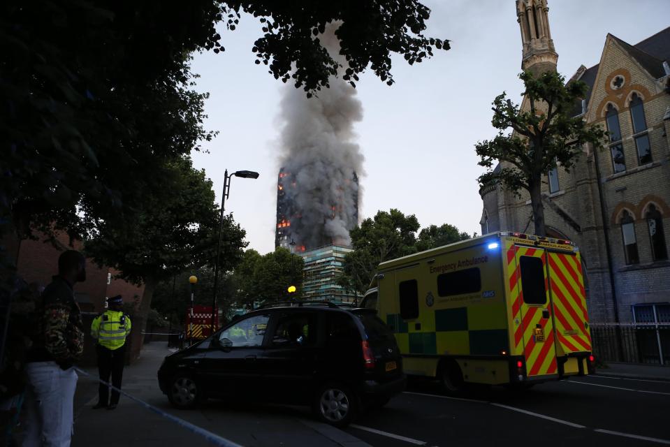  Emergency services at the scene where the building, gutted by fire, is still shrouded in smoke