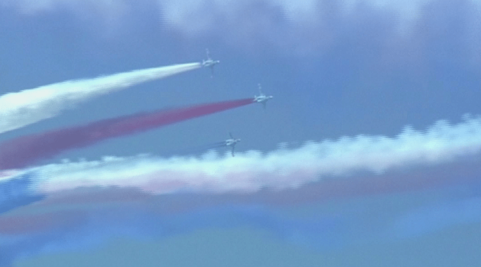  North Korean fighter jets perform a coordinated routine against the backdrop of a bright blue sky