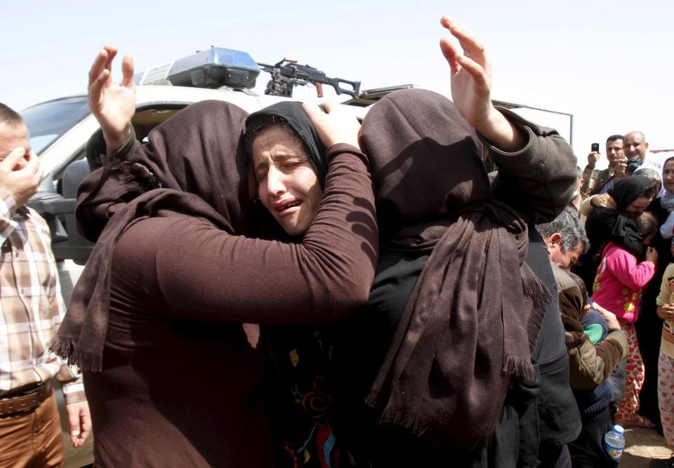  Yazidis released by ISIS hug each other on the outskirts of Kirkuk in April 2015