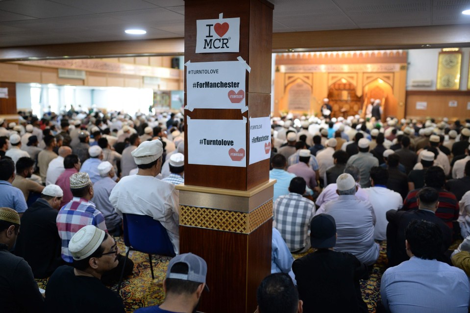 'I Love MCR' signs adorn a pillar as worshippers attend Friday Prayers at Manchester Central Park Mosque