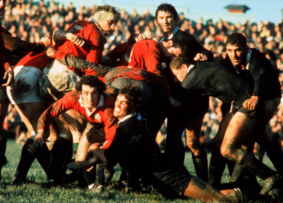 Scrum-half Gareth Edwards is tackled as he attempts to get away a pass