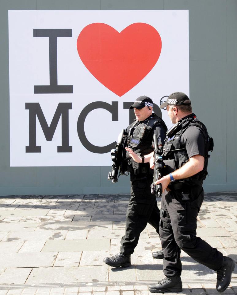  Police officers armed with assault rifles pictured after the Manchester murders