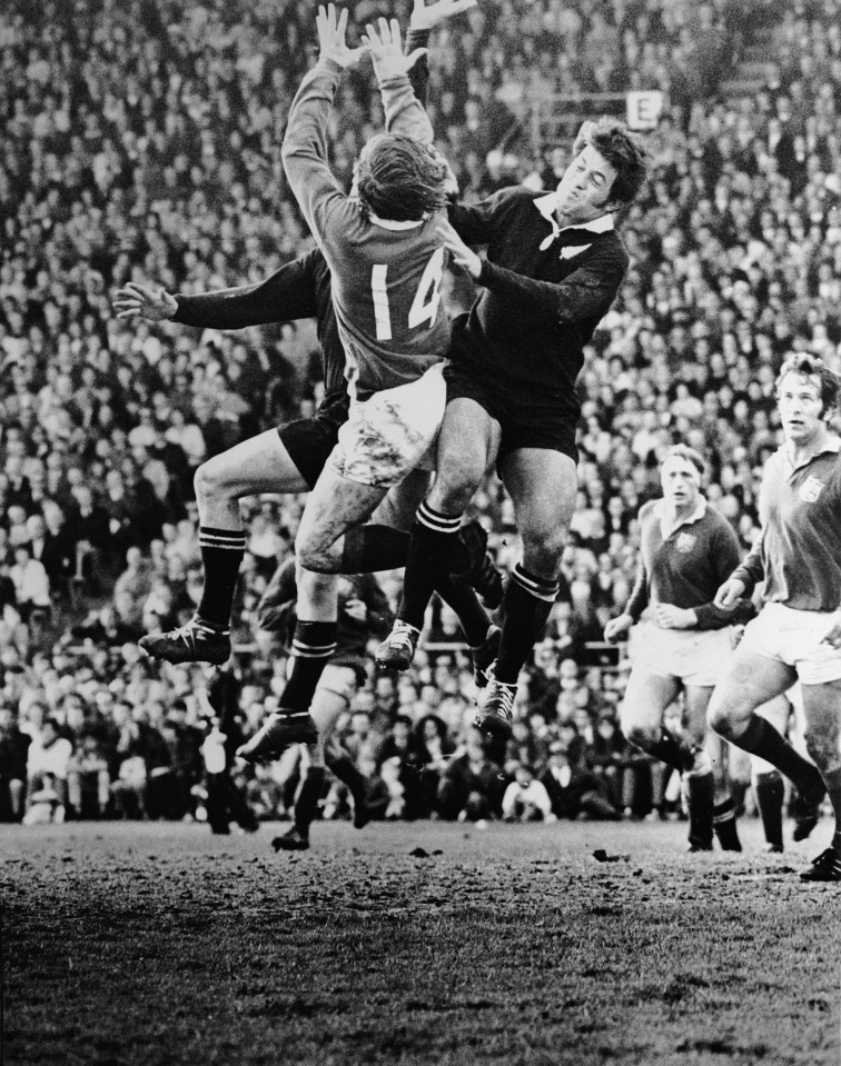 Wingers Gerald Davies and Bryan Williams are in the foreground, with Wayne Cottrell sharing the action. Willie John McBride and John Dawes appear on the right