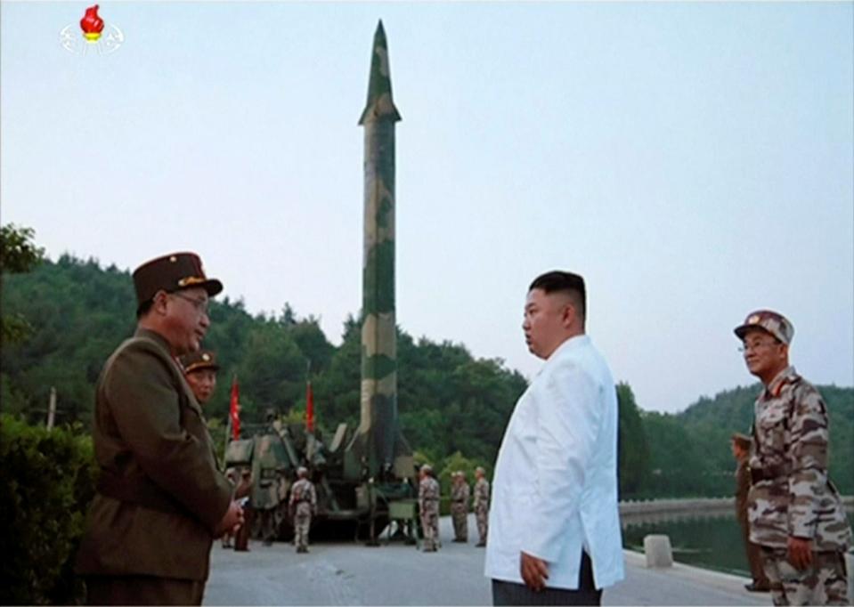  State video still of Kim in front of a missile launcher in North Korea