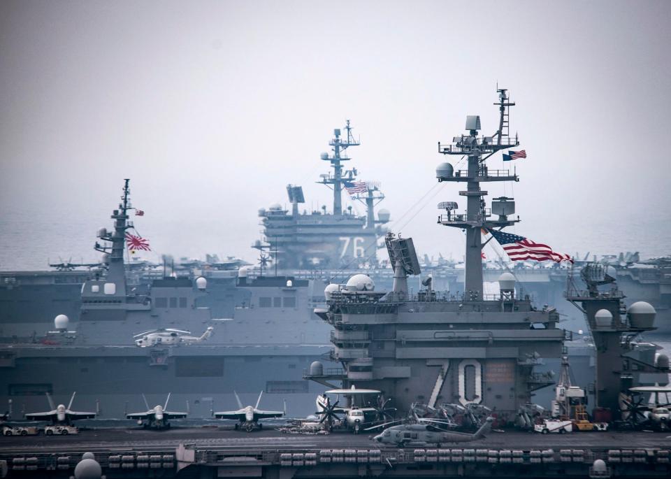  This amazing photograph shows the bridges of the massive supercarriers, with a Japanese vessel in between