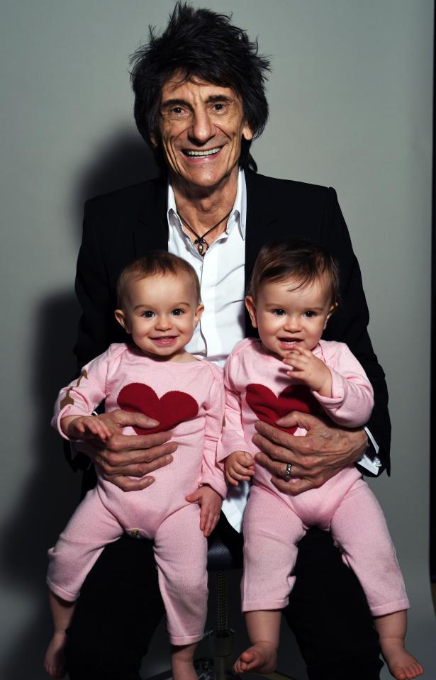  Ronnie poses with his twin daughters