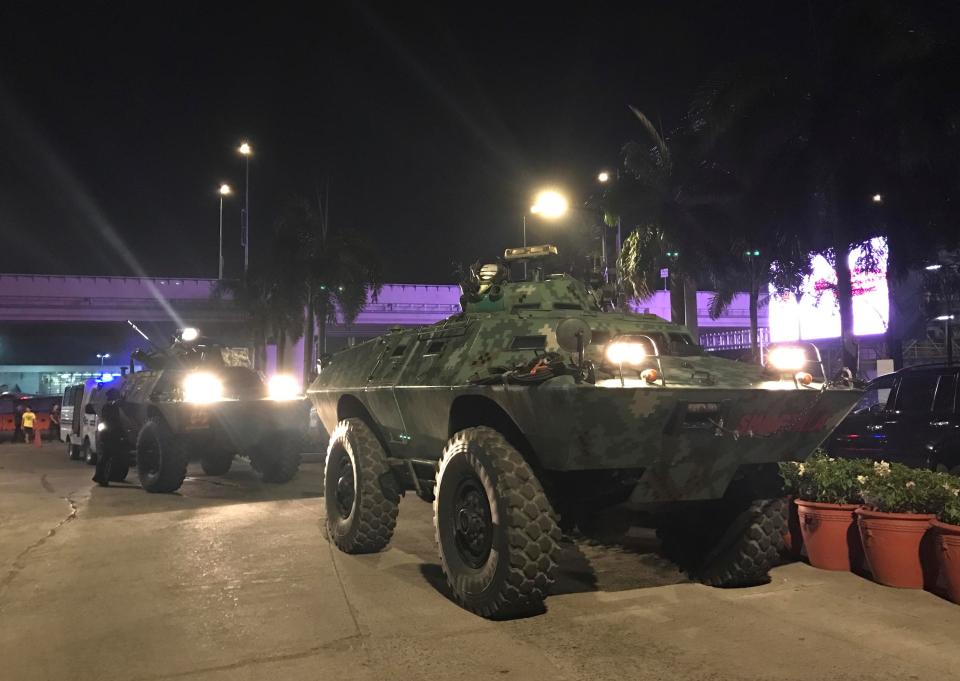  Military vehicles are positioned outside the Resorts World Manila complex