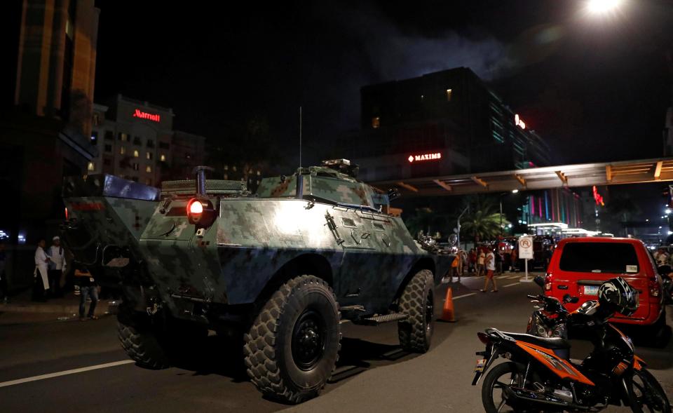  As well as armed officers military tanks were positioned outside the complex