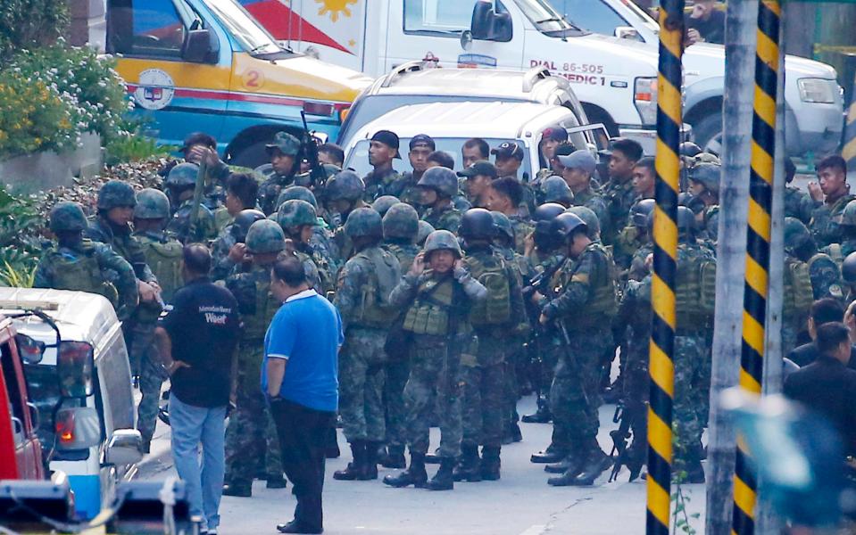  The massed ranks of the Filipino military watched on outside the complex