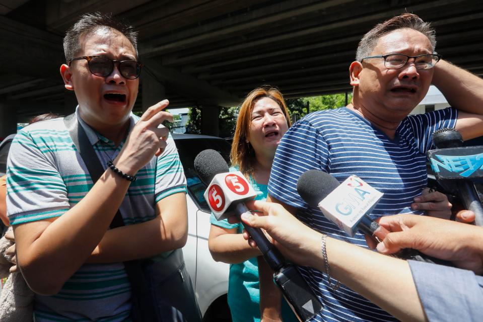  Distraught families waited outside the complex for news about their relatives this morning