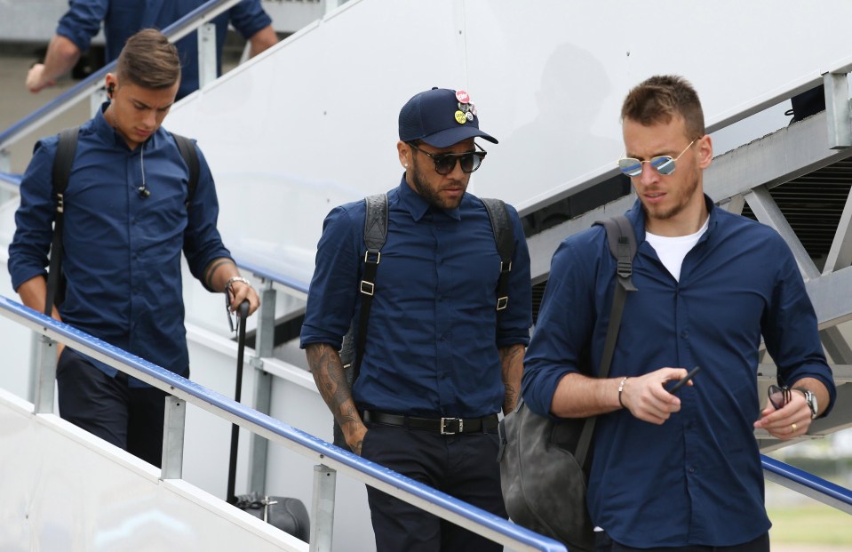 Dani Alves heads off the plane at Cardiff Airport ahead of tomorrow nights Champions League final