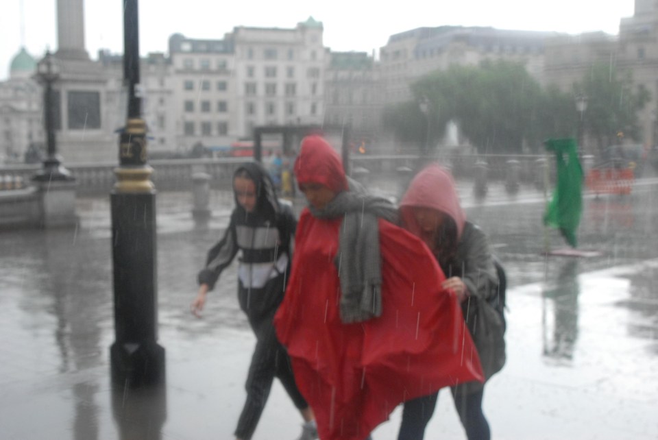 The glorious weather experienced over the last week appears to have come to an abrupt end as people run for cover from the rain in Trafalgar Square this afternoon