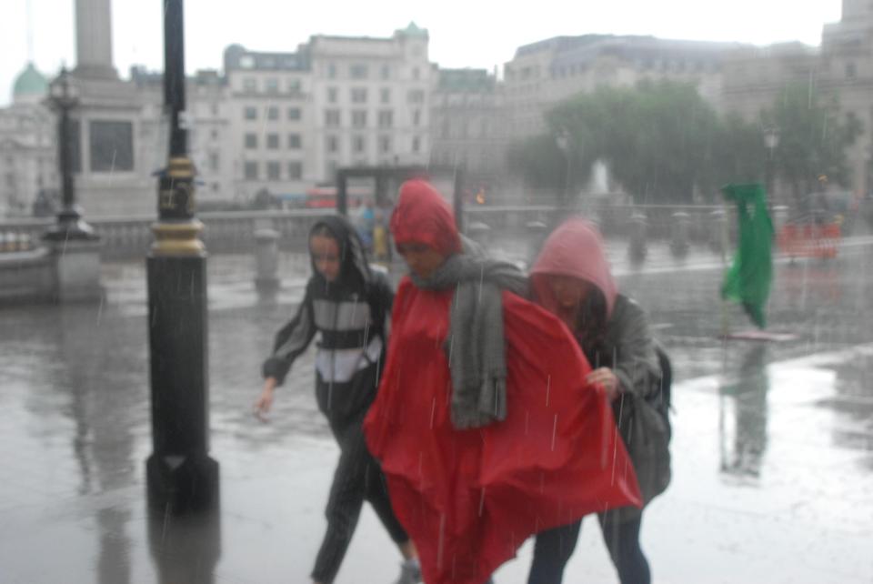  The glorious weather experienced over the last week appears to have come to an abrupt end as people run for cover from the rain in Trafalgar Square this afternoon