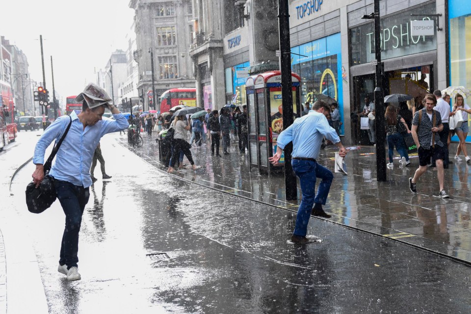 Not dressed for it … one Londoner finds himself caught in the worst of the wet weather