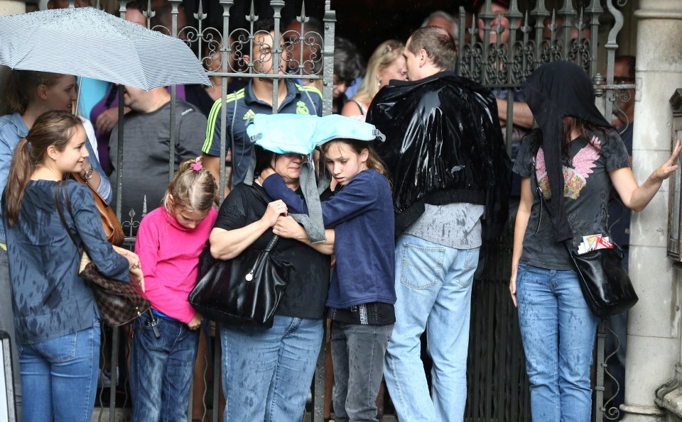 Tourists take shelter as they hide from the rain in Westminster