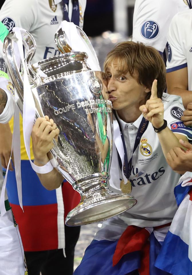  Luka Modric kissed the trophy as he pointed his finger in the air